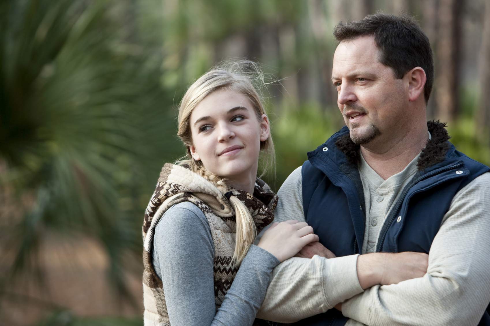 Father and teenage daughter outdoors