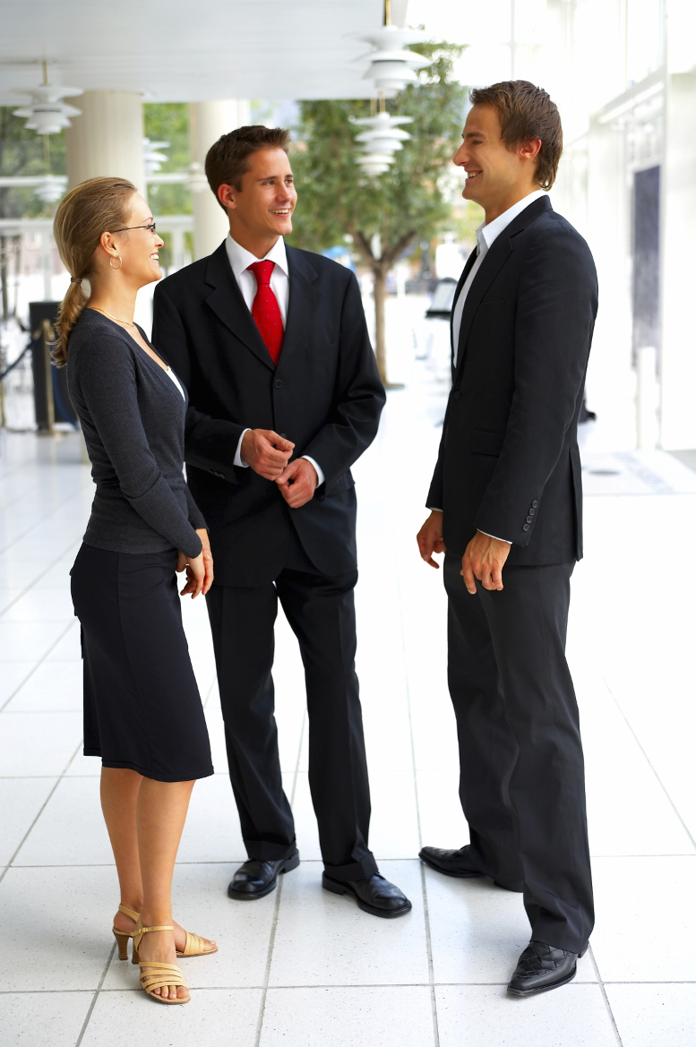 Sophisticated confident business people standing together and having fun